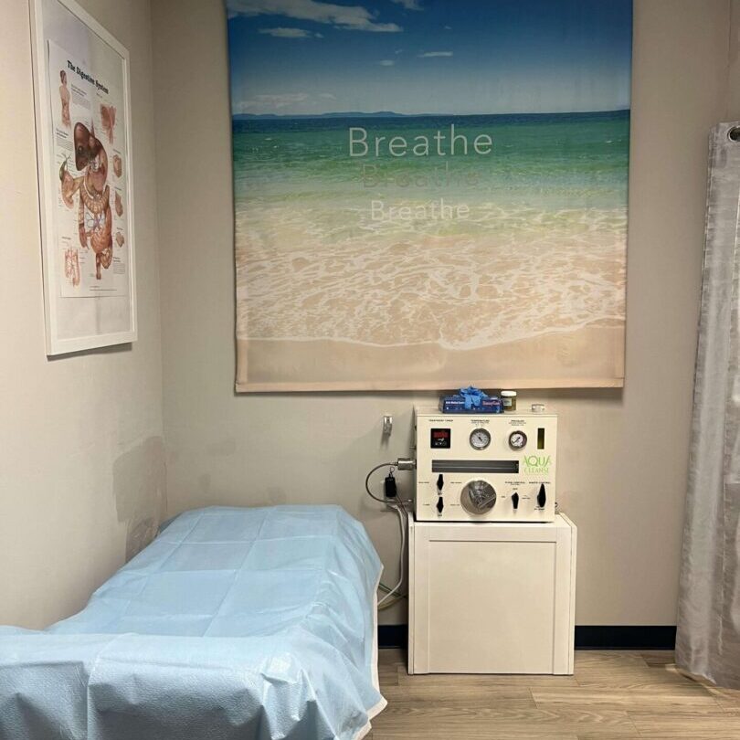 A bed room with a picture of the beach on the wall